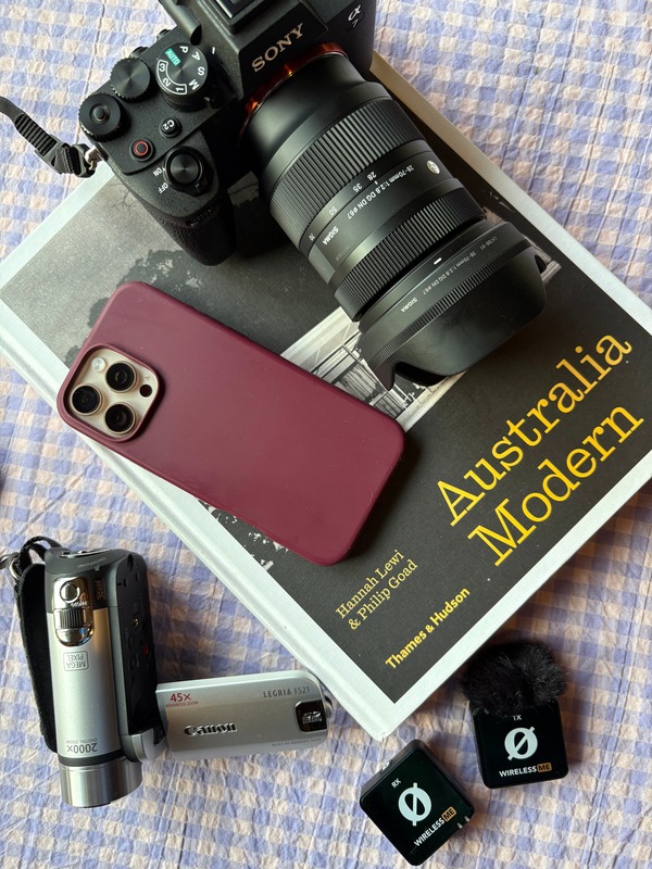 Content kit flatlay with camera, phone, book and microphones